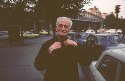 Ivan Wyschnegradsky, adjusting his coat while on a street in Paris (1976)