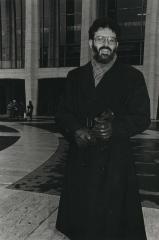A portrait of Charles Amirkhanian standing in front of the Lincoln Center, New York (ca. 1980's)
