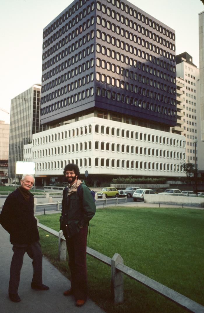 Ivan Wyschnegradsky and Charles Amirkhanian standing in front of modern building, Paris (1976)