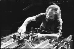 Trimpin, bending over interior of piano, making adjustments, ver 2, 1993