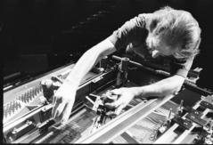 Trimpin, bending over interior of piano, making adjustments, ver 1, 1993