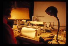 A view over Conlon Nancarrow's shoulder of his piano roll punching machine, 1969