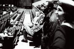 Meredith Monk, Charles Amirkhanian, and Philip Glass seated in the theatre of the Center for the Arts while Foday Musa Suso and Barbara Monk Feldman stand, San Francisco (1993)