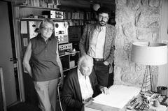 Gladys Nordenstrom, and Charles Amirkhanian, looking at camera, with Ernst Krenek, seated in Krenek's home studio (1985)