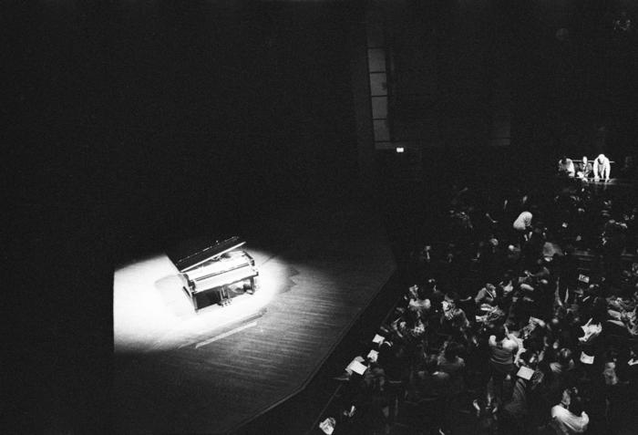 Modified piano and Conlon Nancarrow, in spotlights, in front of audience, ver. 1, San Francisco CA, (1993)