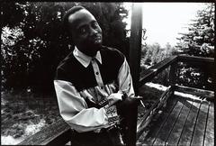 Half length portrait of Foday Musa Suso outside on a deck in Woodside, 1993 (cropped image)