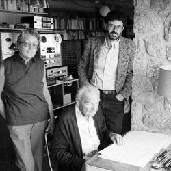 Gladys Nordenstrom, and Charles Amirkhanian, looking at camera, with Ernst Krenek, seated in Krenek's home studio (1985)