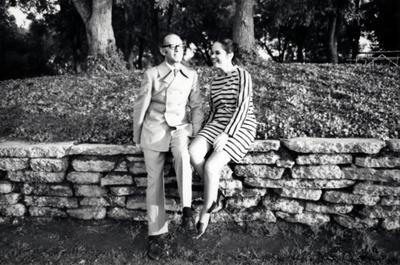 Milton and Peggy Salkind, sitting on stone wall, Putah Creek Lodge, Davis California, 1969
