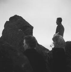 Half length portrait of Mary Oppen (left), Carol Law, and George Oppen, looking out from rocks on Mt. Tamalpais, Mill Valley, CA (1969)