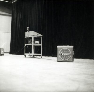 A podium and amplifier on an empty stage, Arena Theater in Fresno, CA (1967)