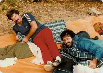 John White and Charles Amirkhanian lying on the ground at Klamath River, 1981