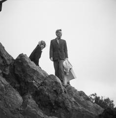 Carol Law sitting on a rock while George Oppen stands, Mt. Tamalpais, Mill Valley, CA (1969)