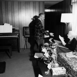 Leo Ornstein standing in front of his wife Pauline who is seated on a couch, Brownsville TX, 1981