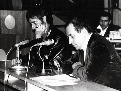 Luc Ferrari & Maurice Fleuret, seated at table with microphones, Amiens, France, 1968