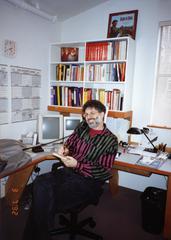 Charles Amirkhanian on the phone, seated, facing forward, Berkeley CA, 1992