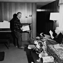 Leo Ornstein, standing next to his piano, facing his seated wife Pauline, Brownsville TX, 1981