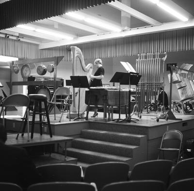 A harpist onstage prior to a performance of Lou Harrison's Easter Cantata, Salinas, CA (1966)