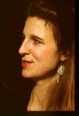 A head and shoulders portrait of Susan Stone, looking left, during Speaking of Music at the Exploratorium (1991)