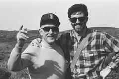 Half length portrait of Erik Bauersfeld (left) and Charles Amirkhanian smiling at Point Reyes, CA (1980s)