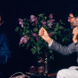 Half length portrait of Mauricio Kagel and Charles Amirkhanian in conversation during Speaking of Music at the Exploratorium, San Francisco (1988)