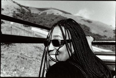 Pamela Z, head and shoulders portrait, facing slightly left, looking over shoulder at camera, Woodside CA, (1997)
