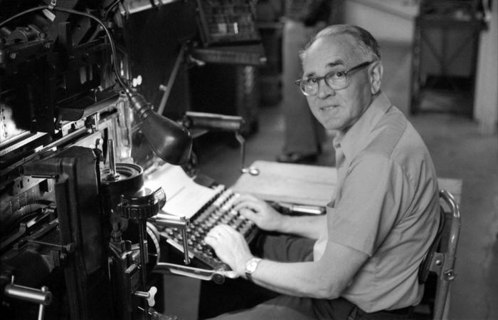 Walter Ellis, seated at keyboard, looking at the camera, 1973