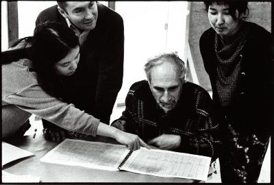 Kui Dong pointing at score while Ionel Petroï, Frederic Rzewski, and Miya Masaoka look on, Woodside, CA (1996)