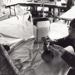 Alvin Lucier looks on as Margaret Leng Tan adjusts a teapot wired for sound, (1999)