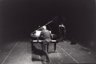 Peter Garland and William Winant, setting up piano and equipment, 2000 (cropped image)