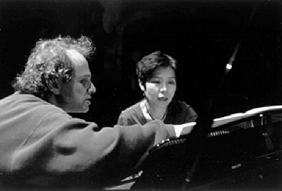David Lang & Aki Takahashi, heads and shoulders portrait, looking at musical score, San Francisco CA, (2000)