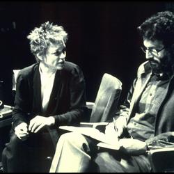 Laurie Anderson facing Charles Amirkhanian, seated onstage during Speaking of Music, San Francisco (1984)