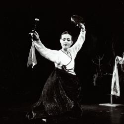 Eun-ha Park, full length portrait, facing forward, performing a dance with percussion, San Francisco, 2001 (cropped image)