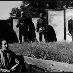 Maria de Alvear in a site sculpture, with Charles Amirkhanian, Billy Bang, and Michael Nyman standing on ground above, Woodside, CA (2005)