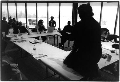 Maria de Alvear, kneeling on table with back to camera, during a private presentation with fellow OM 11 composers, Woodside, CA (2005) [Duplicate]