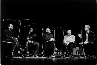 Seth Josel, Daniel Bernard Roumain, Michael Nyman, and Phil Niblock seated onstage with Charles Amirkhanian for a panel discussion during the 11th Other Minds Festival, San Francisco, CA (2005)