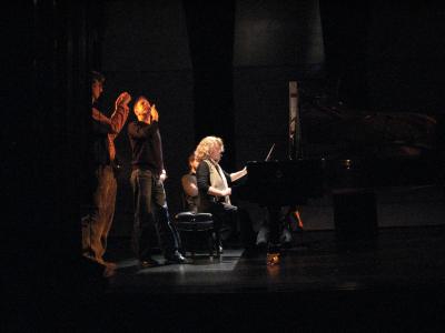 Lisa Moore, seated at piano, surrounded by John Fago (left) and two unidentified men, San Francisco CA., (2008)
