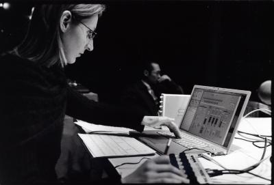 Dobromiła Jaskot, head and shoulders portrait, seated, performing with laptop and electronic interface, 2009 (cropped image)