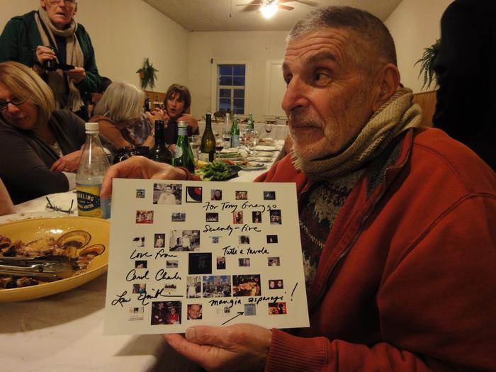 Anthony Gnazzo, in profile, holding a card during his 75th birthday celebration (2011)