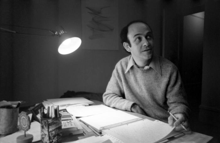 Charles Dodge, half-length portrait, seated at desk with lamp, facing right, New York City, 1975