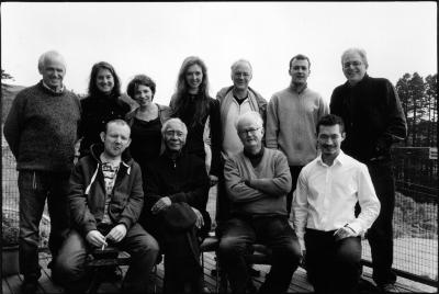 Featured OM 15 composers with festival organizers, standing and sitting, facing forward, Woodside (cropped image)