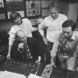 Brian Eno at the control board with KPFA staff during Brian Eno Day, 1988
