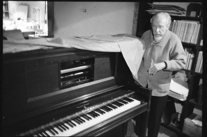 Conlon Nancarrow, standing by one of his player pianos, Mexico, 1990
