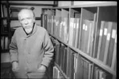 Conlon Nancarrow, standing next to shelves of records in his home studio, Mexico, 1990