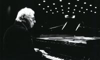 Harold Budd, seated and playing a piano during rehearsals prior to OM 17, San Francisco CA (2012)