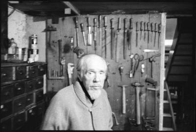 Conlon Nancarrow, standing in front of his wall of tools, Mexico, 1990