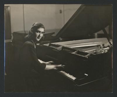 Portrait of Maro Ajemian, seated at a piano, facing camera (ca. 1940s)