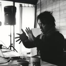 Ken Ueno, seated and talking during his presentation at the Djerassi Resident Artists Program, Woodside CA (2012)