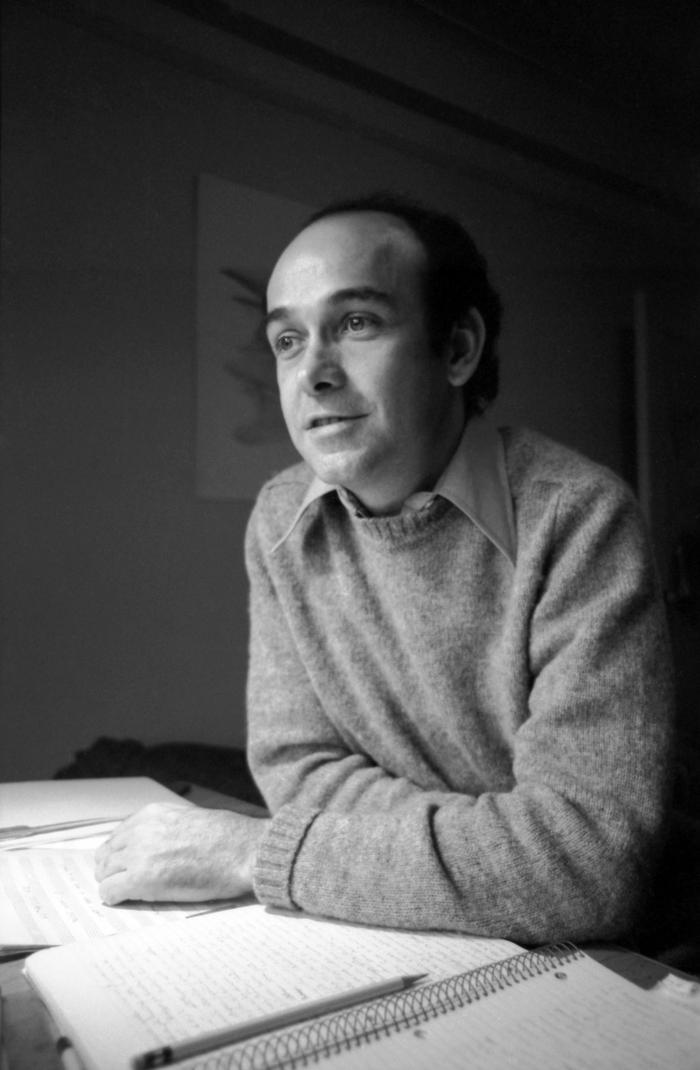 Charles Dodge, half-length portrait, seated at table, facing slightly left, New York City, 1975