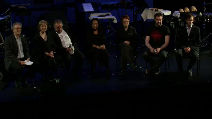 Panel discussion participants seated onstage prior to the third concert of OM 18, vs.2, San Francisco CA (2013)