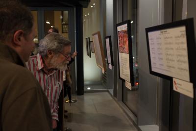 Don Buchla looking at Myra Melford's score in the auction exhibit during OM 19 (2014)